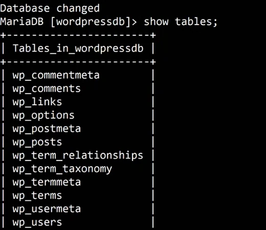 A black terminal. MariaDB prints Database changed, then the prompt MariaDB [wordpressdb]> show tables; and a table headed Tables_in_wordpressdb listing wp_commentmeta, wp_comments, wp_links, wp_options, wp_postmeta, wp_posts, wp_term_relationships, wp_term_taxonomy, wp_termmeta, wp_terms, wp_usermeta and wp_users.